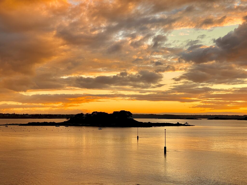 Beau coucher de soleil aux tons jaune et orange à Saint-Briac-sur-Mer, commune située sur la Côte d'Émeraude en Bretagne.